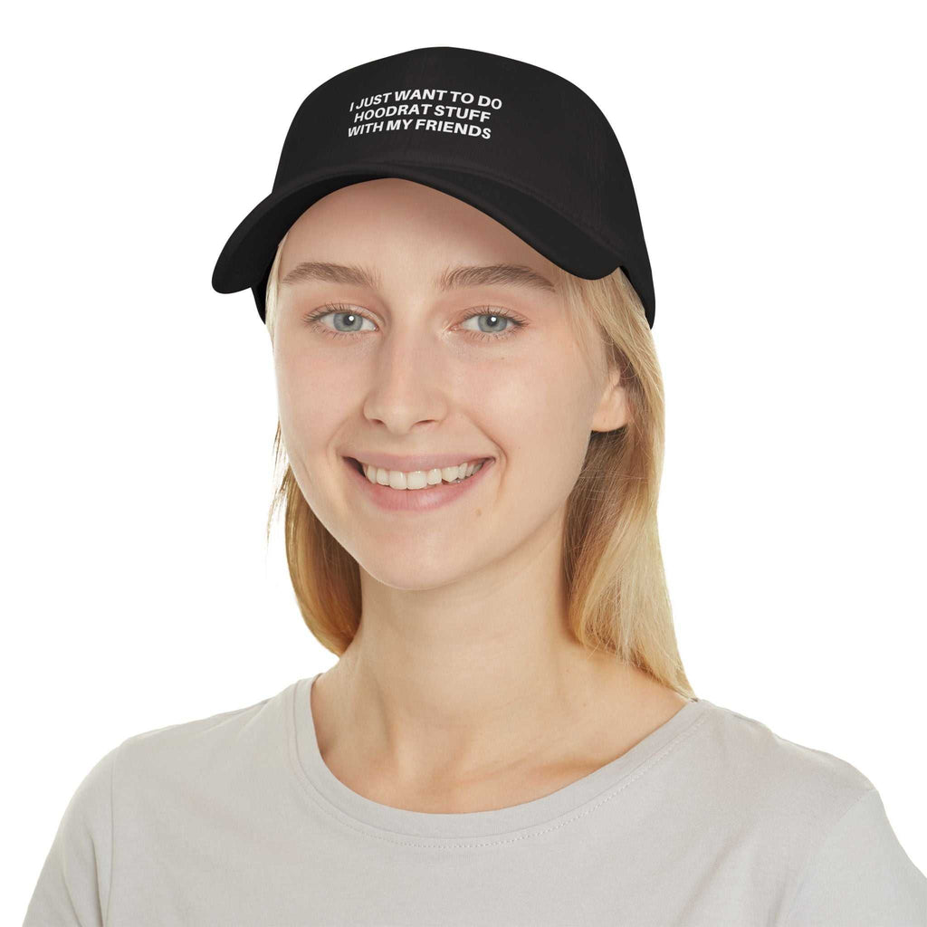 Young woman wearing black Low Profile Baseball Cap with embroidered text "I JUST WANT TO DO 'HOODRAT STUFF' WITH MY FRIENDS"