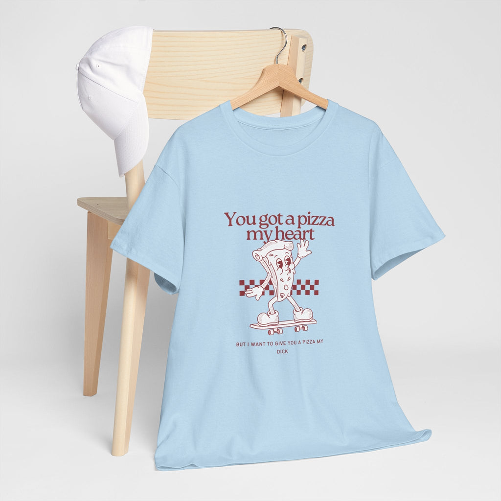 Light blue Pizza This Dick t-shirt with humorous pizza graphic and text, laid casually by wooden chair with white cap.