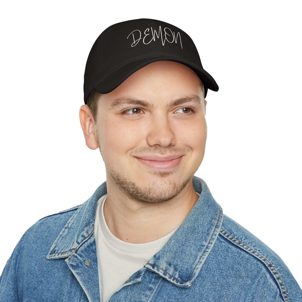 Black Demon Script Baseball Cap low-profile cotton hat with adjustable Velcro strap worn by man in denim jacket
