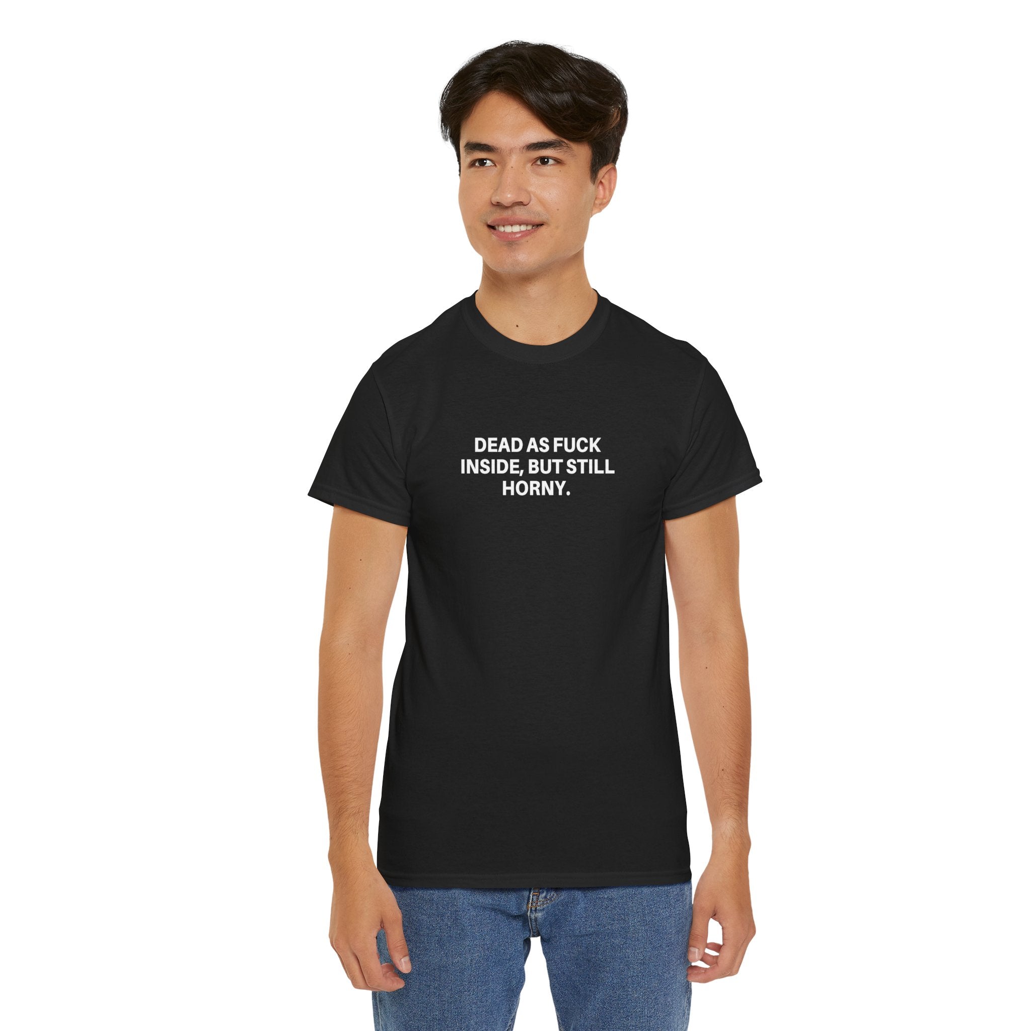 Black Printify T-shirt featuring "Dead as F***" graphic in bold white lettering, displayed flat on a wooden surface.